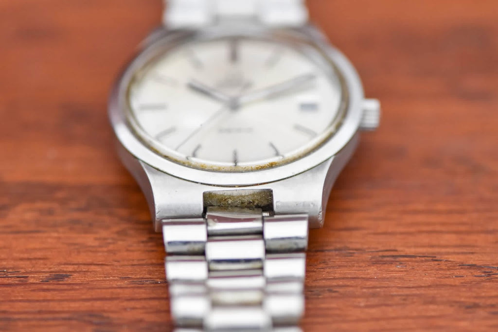 Omega Genève dial close up showing warm patina at the dial edge