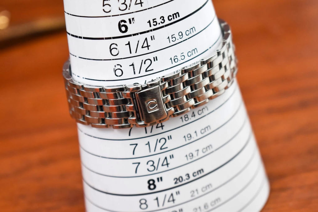 Omega De Ville Prestige bracelet measured against a sizing card