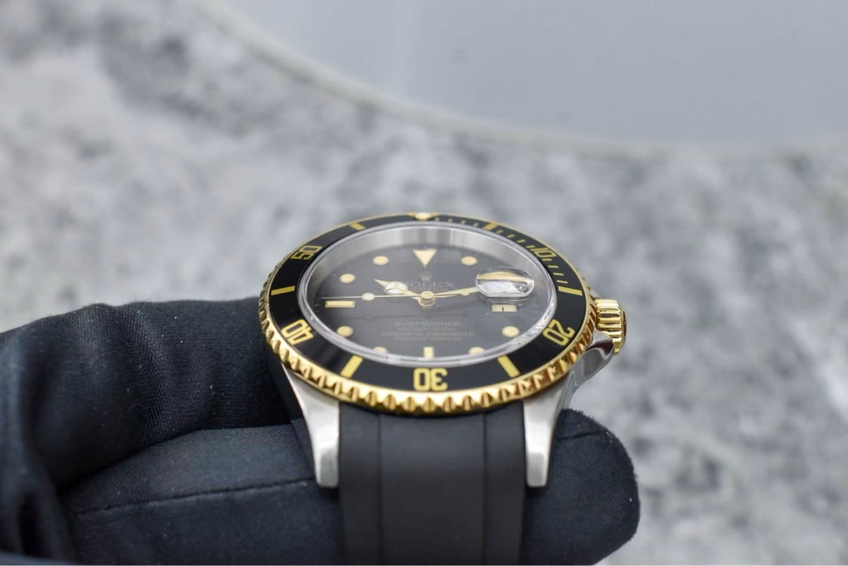Rolex Submariner 16613 in hand, dial and dive bezel detail