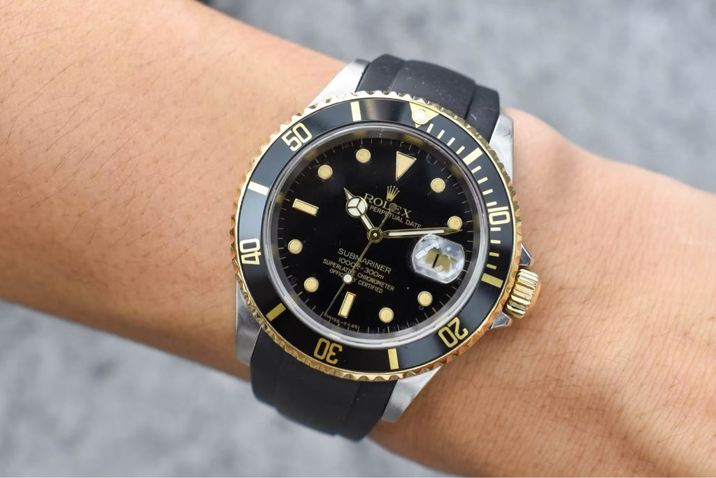 Rolex Submariner 16613 angled wrist shot showing gold bezel and black dial