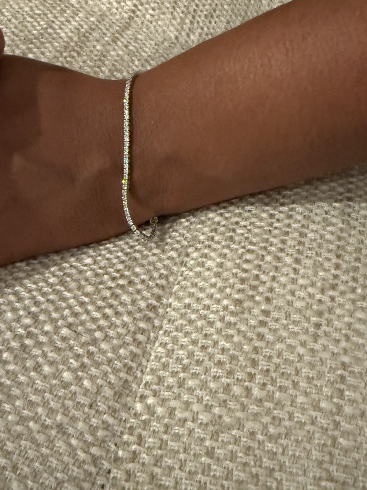 Lab diamond tennis bracelet draped, showing continuous line of round brilliants