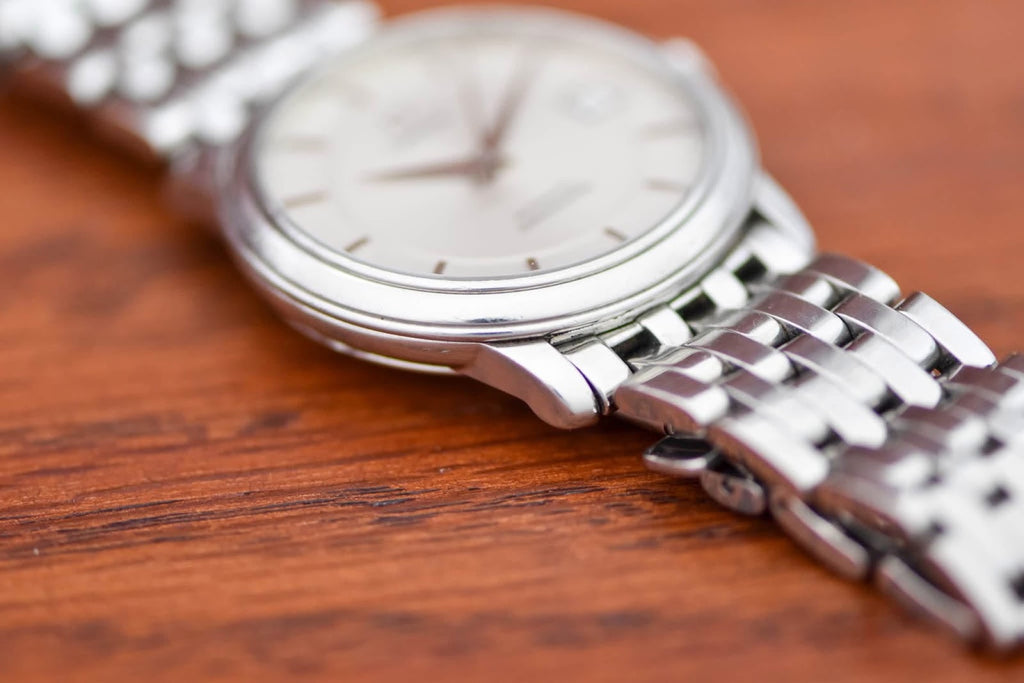 Omega De Ville Prestige low angle showing slim case profile and tapering bracelet