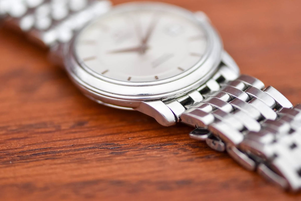 Omega De Ville Prestige low angle showing slim case profile and tapering bracelet