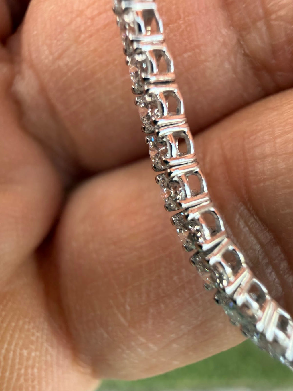 Side profile of the tennis bracelet showing the four-prong setting gallery