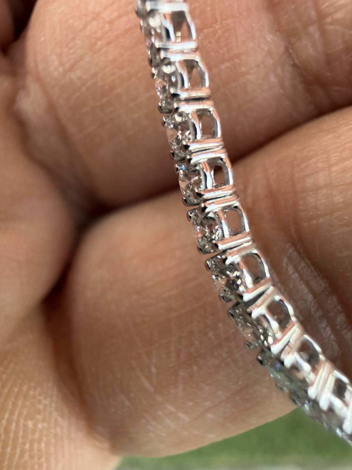 Side profile of the tennis bracelet showing the four-prong setting gallery