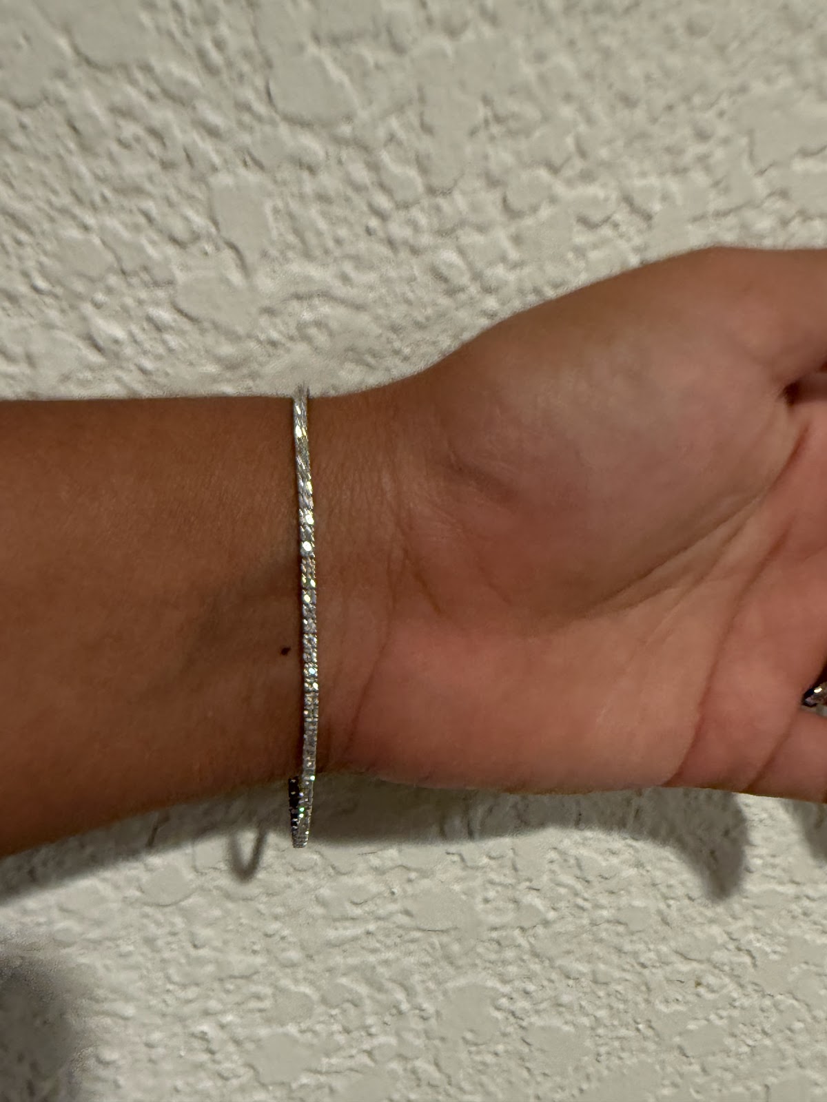 3 carat lab diamond tennis bracelet worn, side profile of the setting