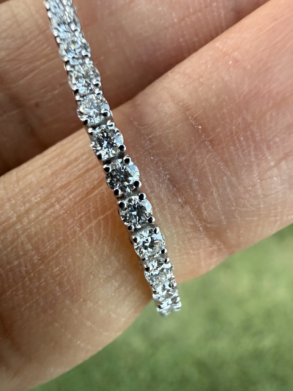 Close-up of round brilliant lab diamonds in four-prong settings on the tennis bracelet