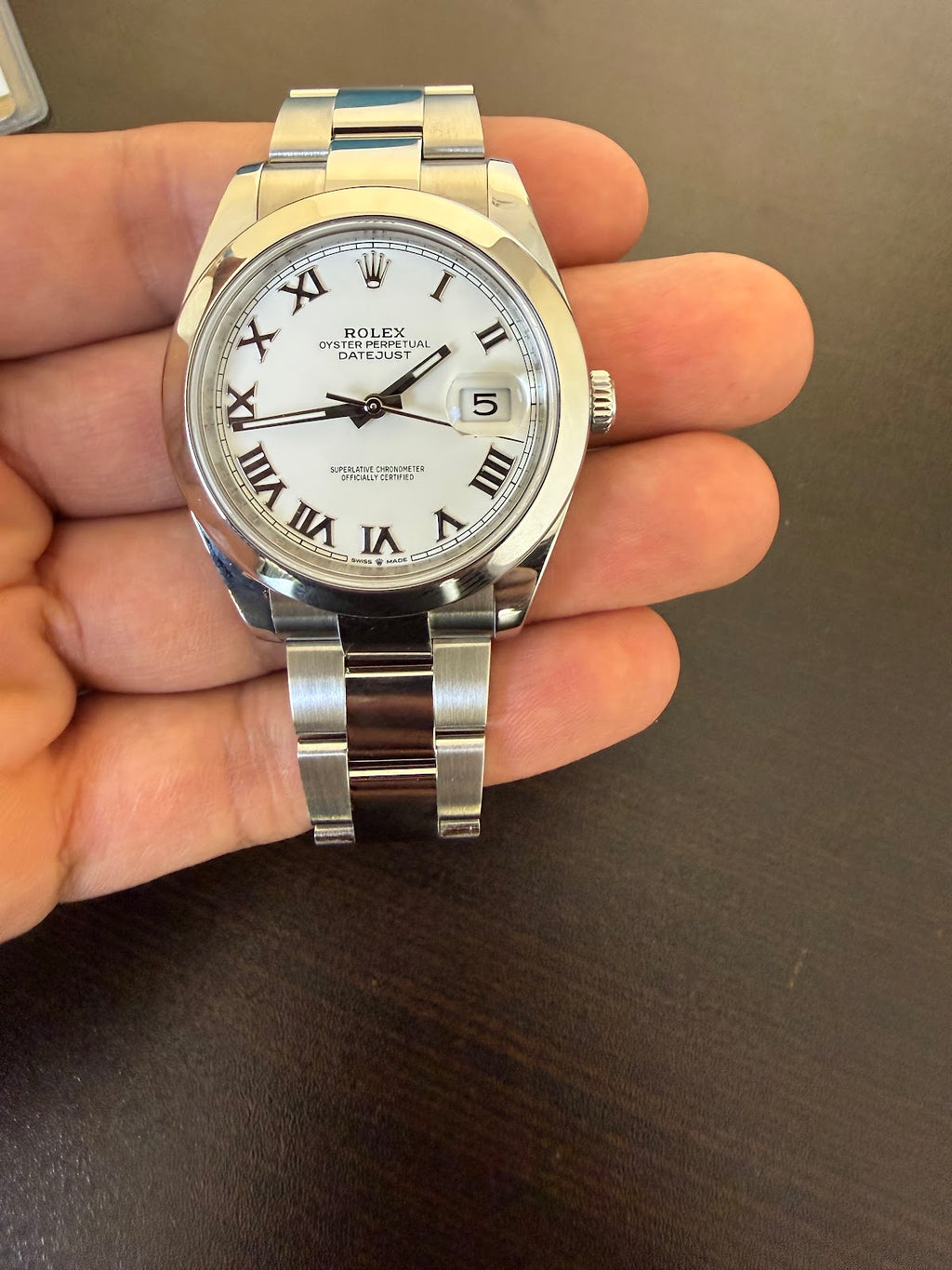 Rolex Datejust 41 white Roman dial straight on, showing date window and smooth domed bezel